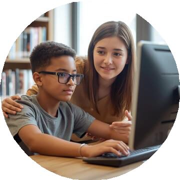Two teenagers learning together at a computer