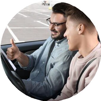 A driving instructor giving a learner driver a thumbs up