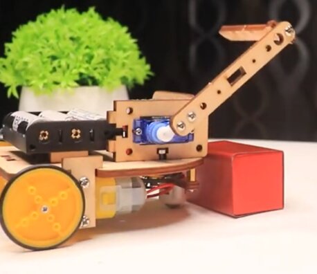 A wooden robot car with a servo-powered arm